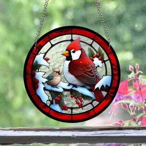 Close-up detail of circular acrylic stained glass suncatcher hanging with a cardinal.