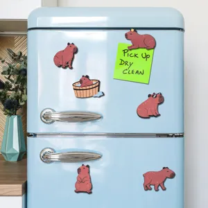 Süße hölzerne Wasserschwein Kühlschrankmagnete an einem blauen Retro-Kühlschrank.