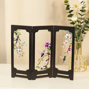 Detailed view of vintage miniature folding screen with stained glass hummingbird floral pattern.