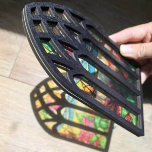 Close-up detail of the wooden gothic window ornament showing colorful stained glass effect.