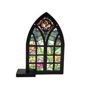 Stained glass window ornament detail showing dragonfly pattern and gothic wooden frame.