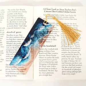 Creative translucent acrylic bookmark featuring ocean wave design and elegant golden tassel.