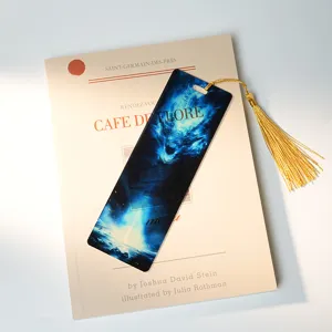 Translucent acrylic bookmark with fantasy blue dragon design and gold tassel for reading books.
