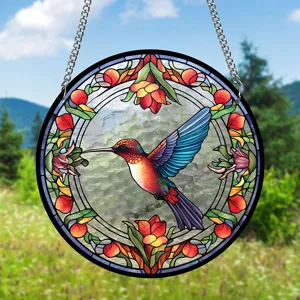 Detailed view of the colorful stained glass hummingbird suncatcher hanging outdoors.