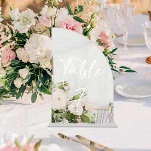 Clear detail shot of an acrylic arched table number sign with elegant handwriting design.