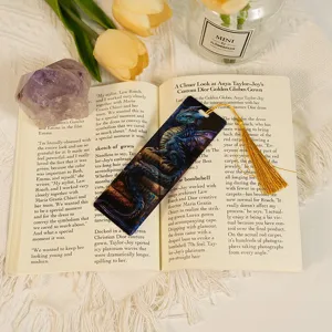 Translucent acrylic dragon bookmark with golden tassel, vintage aesthetic reading accessory.