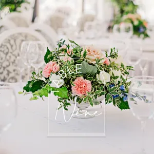 Clear acrylic wedding table number sign with elegant white arched design and lettering.