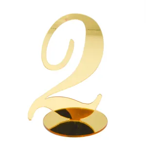 Gold acrylic table number 2 with round base for wedding party restaurant decor detailing.