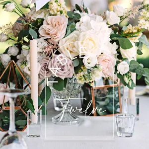 Acrylic arch wedding table number sign details showing elegant white typography setup.