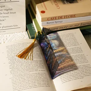 Acrylic dragon bookmark with golden tassel detail, elegant reading accessory for books.