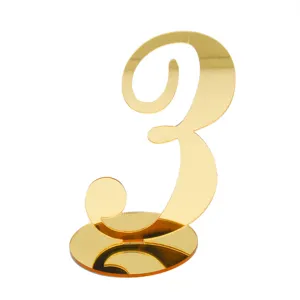 Gold acrylic table number 3 detail, reflective surface sign for wedding and restaurant decor.