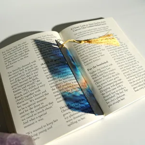 Creative translucent acrylic bookmark with golden tassel, colorful refraction light design.