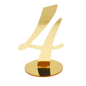 Gold acrylic number 4 table sign detail, elegant mirror finish wedding placeholder decor.
