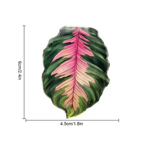 Aimant de réfrigérateur ou accessoire décoratif en acrylique motif feuille tropicale rose et verte.