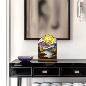 Detailed view of the stained glass style acrylic mountain and sunset tabletop ornament.