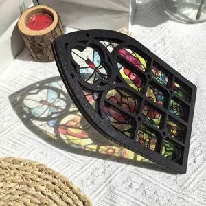 Detailed view of the gothic style wooden stained glass window decor piece casting colorful shadows.