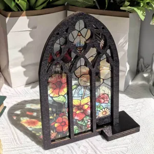 Wooden arched window tabletop decor with stained glass floral design for home interior display.