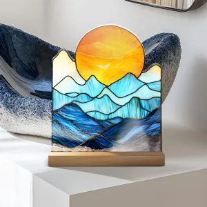Stained acrylic sunset mountain tabletop ornament with wooden base for modern home decor display.