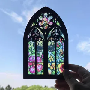 Stained glass window hanging detail, gothic arch wood frame with floral and butterfly pattern.