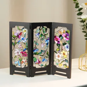 Close-up detail of the vintage stained glass miniature folding screen table decor item.
