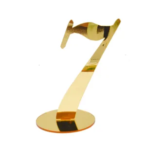 Gold acrylic table number 7 sign detail for wedding reception and restaurant dining decor.
