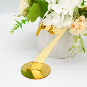 Detailed close-up view of the golden mirror acrylic table number 7 showing exquisite finish.