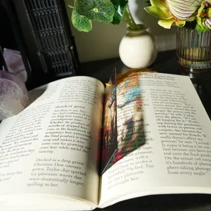 Detailed close-up of a colorful translucent acrylic bookmark with artistic design and tassel.