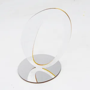 Clear acrylic table sign detail, transparent wedding number holder bracket display closeup.