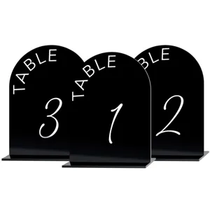 Black acrylic table numbers with white arched design, perfect for wedding party decor.