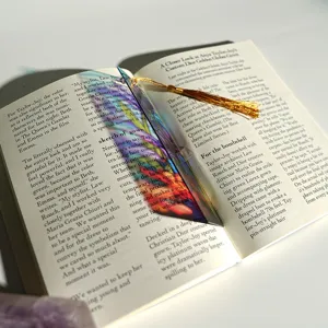 Colorful transparent acrylic bookmark with golden tassel, beautiful light refraction design.