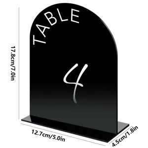 Acrylic table number sign detail view, black arched design with white text, wedding decor.