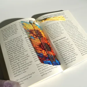Detail shot of a creative colorful light-transmitting acrylic bookmark with golden tassel.