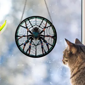 Detailed view of the stained glass spider suncatcher hanging by the window with a cat.