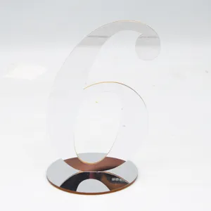 Detailed shot of clear acrylic number six table sign with a reflective round base, smooth edge.