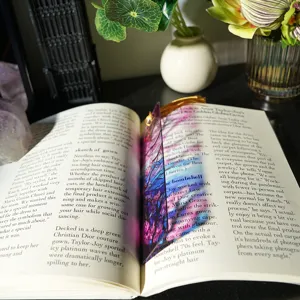Colorful translucent acrylic bookmark with tassel, artistic stained glass design for reading.