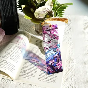 Transparent acrylic bookmark featuring vibrant cherry blossom stained glass art and a gold tassel.