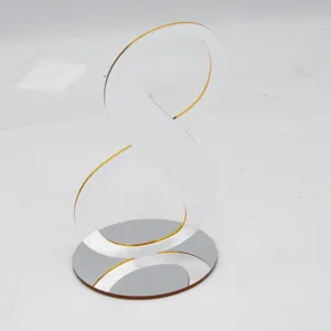 Clear acrylic number 8 table sign with mirror base for wedding party and restaurant decor.