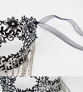 Exquisite black metal masquerade mask featuring sparkling rhinestones and crystal fringe.