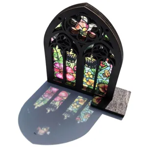 Detailed view of wooden stained glass window ornament, gothic arched tabletop floral decor.