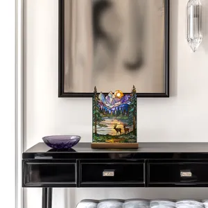 Detailed view of the scenic stained glass style acrylic table lamp featuring deer and mountains.