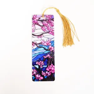 Acrylic transparent bookmark with cherry blossom design and golden tassel for reading lovers detail view