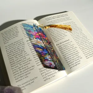 Colorful translucent acrylic bookmark with gold tassel, artistic refractive design.