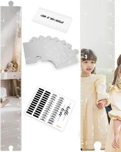 Acrylic mirror height growth chart detail featuring puzzle pieces, ruler scales and milestone stickers.