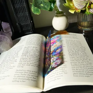 Translucent acrylic bookmark detail showing colorful refractive light and elegant tassel charm.