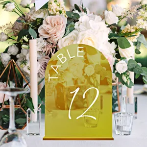 Gold acrylic arched table number sign detail showing elegant wedding table setup and decor.