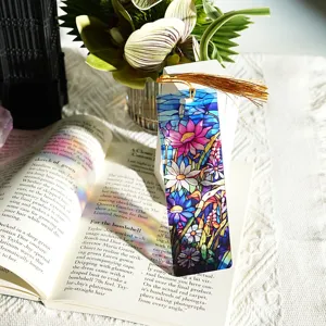 Detailed view of a colorful stained glass acrylic bookmark featuring an elegant gold tassel.