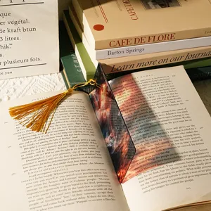 Translucent acrylic bookmark with artistic dragon pattern and gold tassel for reading books.