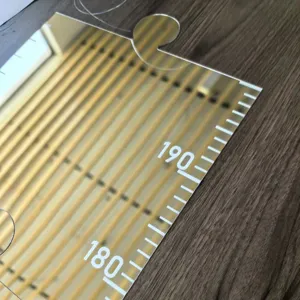 Acrylic mirror height chart detail shot, wall hanging growth ruler scale close up.