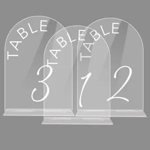 Clear acrylic arched table numbers with stands, perfect for wedding reception and event decor.