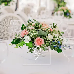 Acrylic wedding table number sign with arch design and clear stand for event decor.